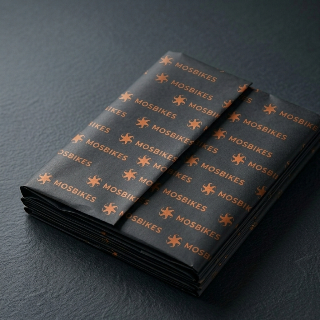 Mosbikes brand identity mockup showing logo applied on printed material